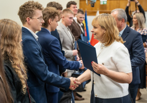 Zdjęcie wyróżnionych uczestników, uczniów Technikum nr 1 w Tomaszowie Mazowieckim, w projekcie „Młodzi zawodowcy – program stypendialny Województwa Łódzkiego” odbierających gratulacje.